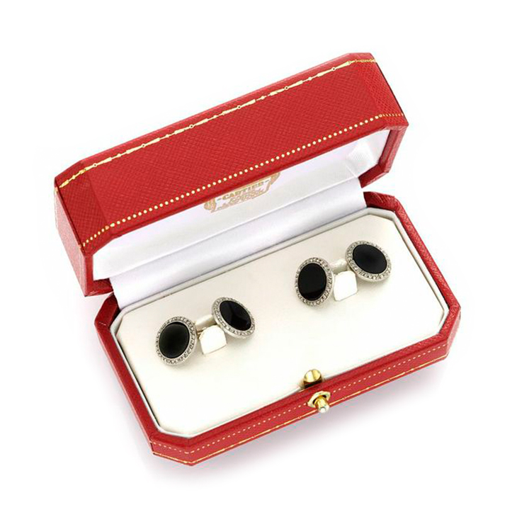 A Pair of Art Deco Onyx and Diamond Cufflinks, by Cartier, circa 1920