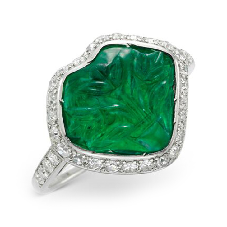 An Art Deco Carved Emerald, Diamond and Black Enamel Ring, circa 1925