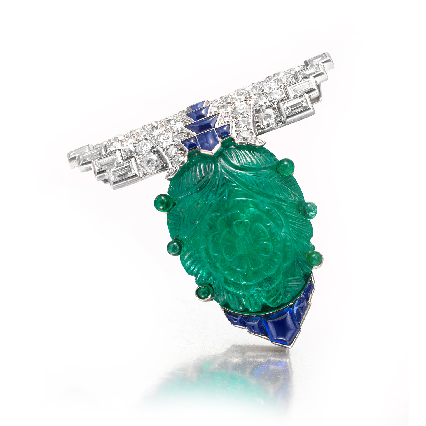 An Important Art Deco Carved Emerald, Sapphire and Diamond Clip Brooch, by Cartier, circa 1925