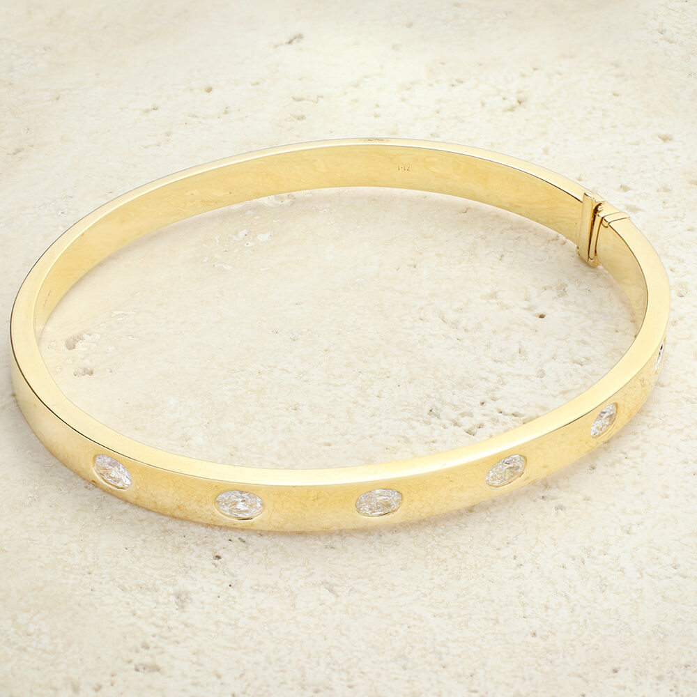 Oval Shaped Diamond and Gold Bangle Bracelet
