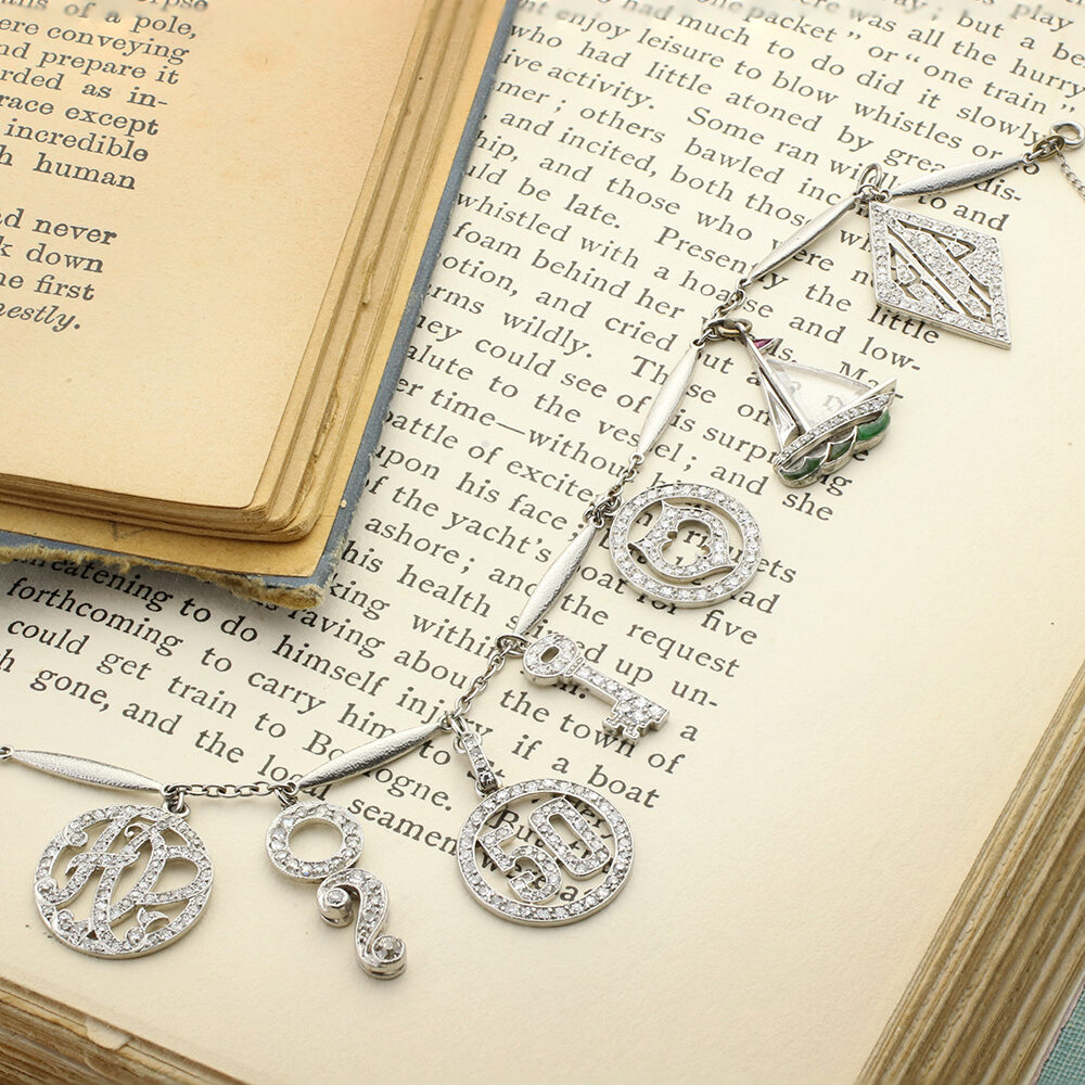 Art Deco Platinum, Diamond and Gem-set Charm Bracelet