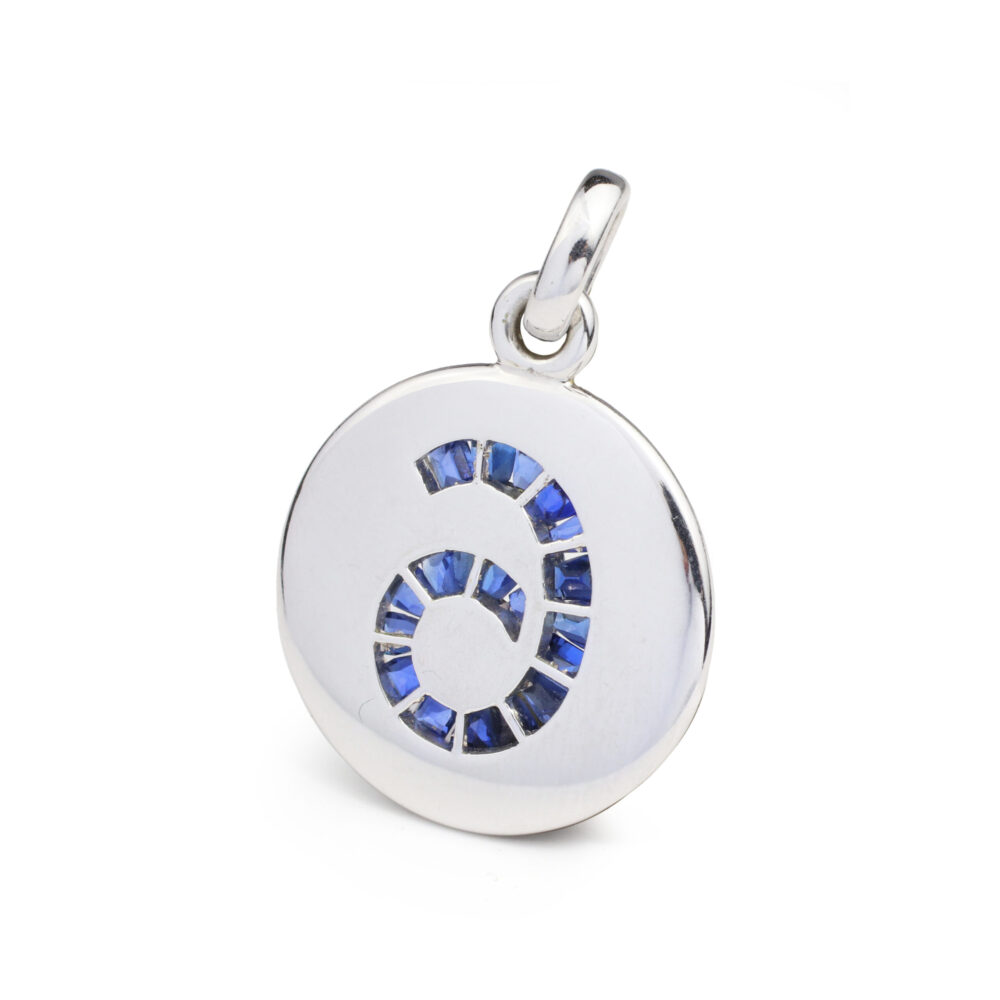 Designed a large round charm accented with a calibre cut sapphire set number 6, circa 1990